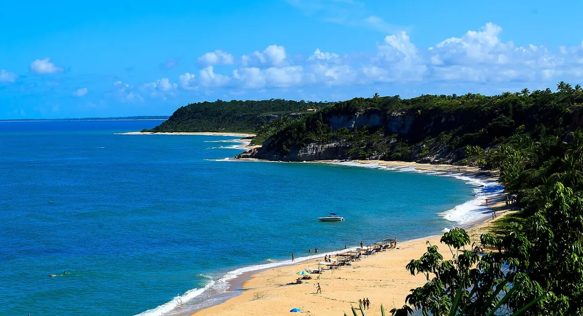 Praia do Espelho em Trancoso, Bahia, vista aérea com falésias e mar azul cristalino.